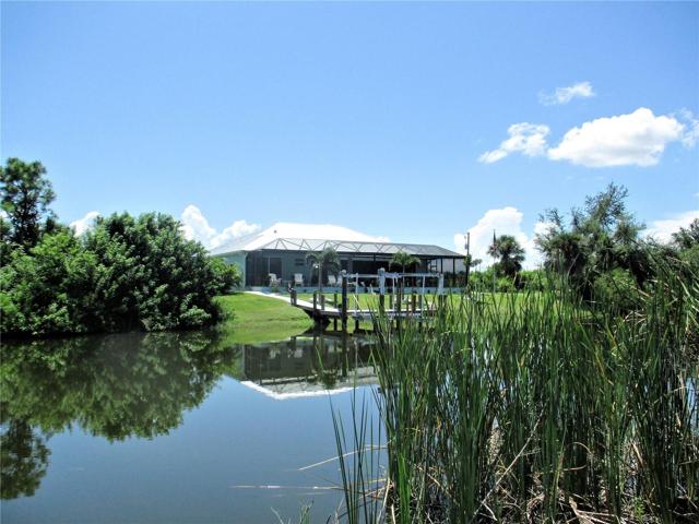 Home with pool and dock across canal