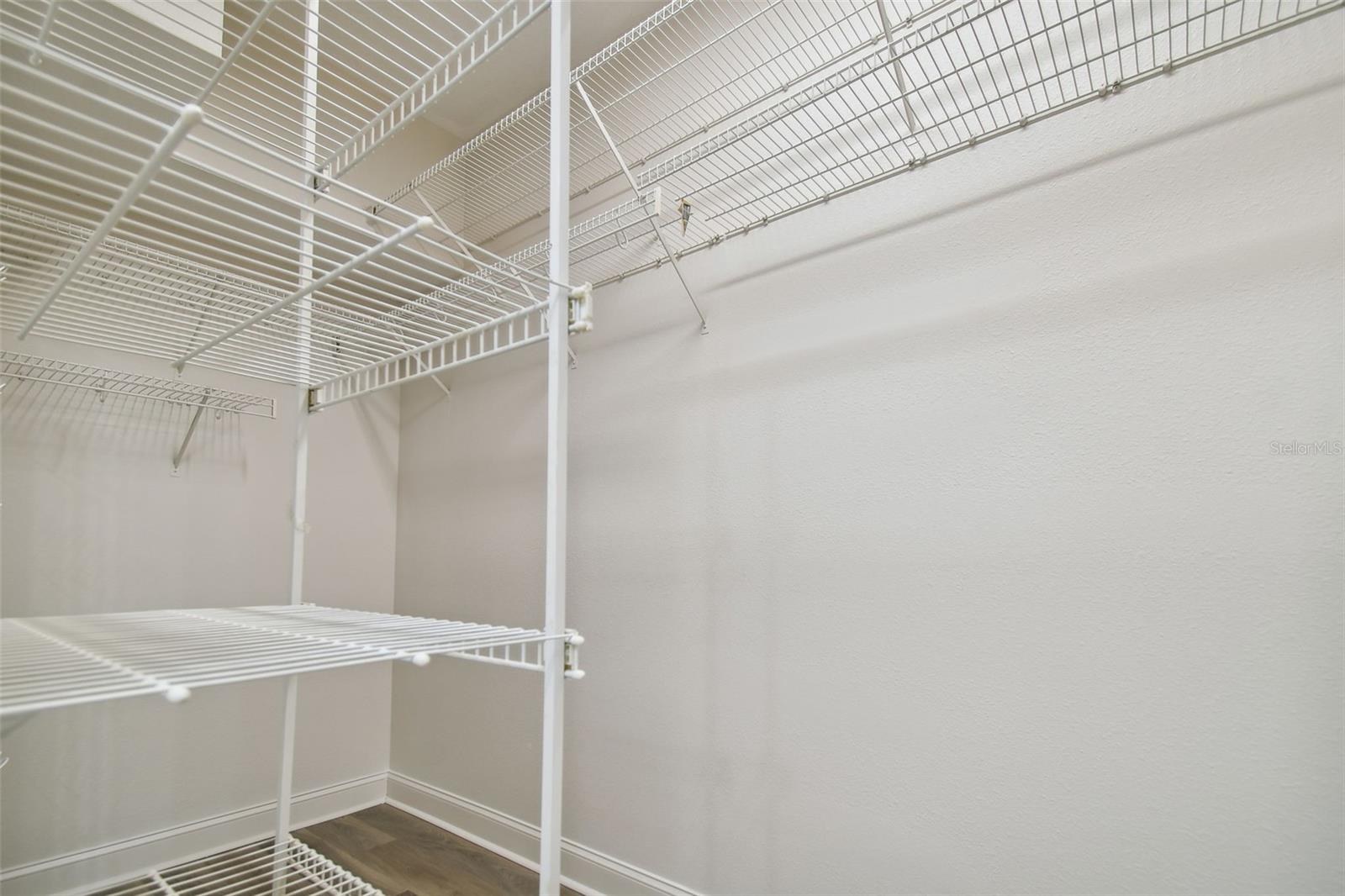 Primary bedroom walk in closet