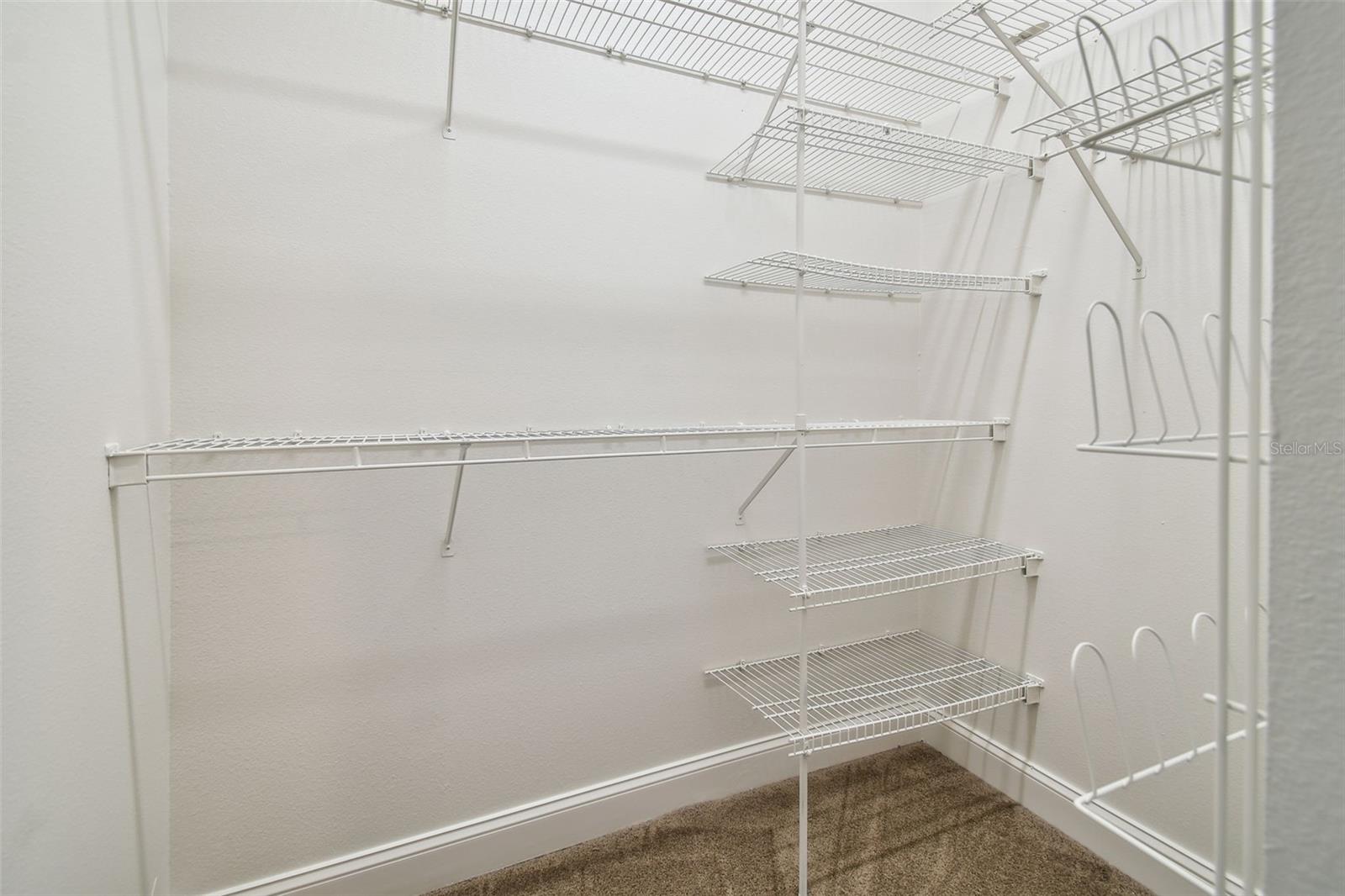 Primary bedroom walk in closet