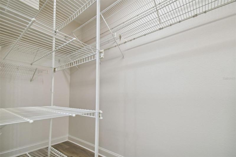 Primary bedroom walk in closet
