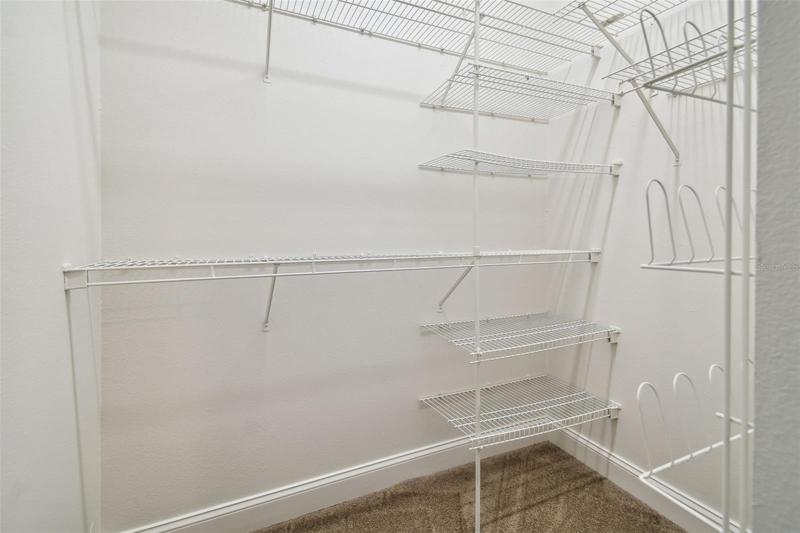 Primary bedroom walk in closet