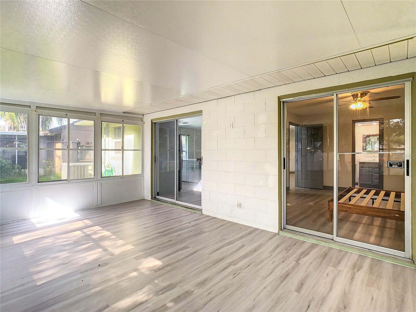 FLORIDA ROOM SLIDING DOOR VIEWS TO MASTER AND DINING/LIVING AREA