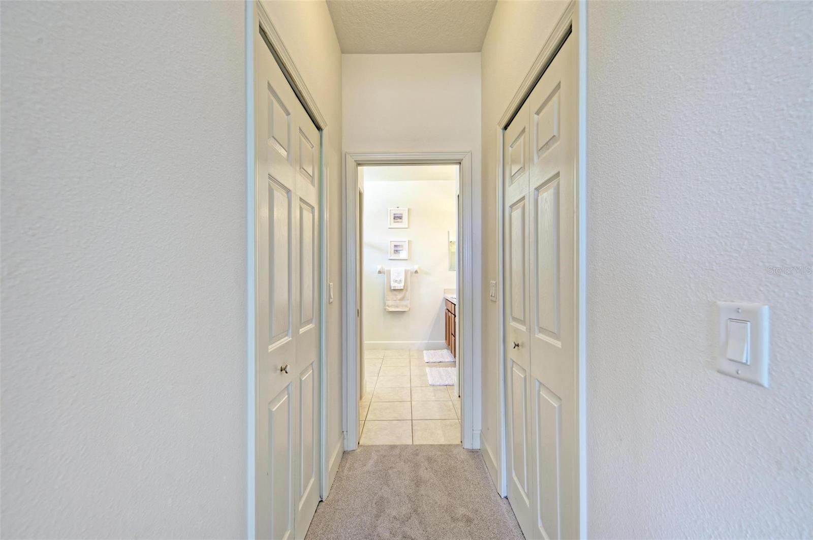 Walk-in closets on either side of the hallway