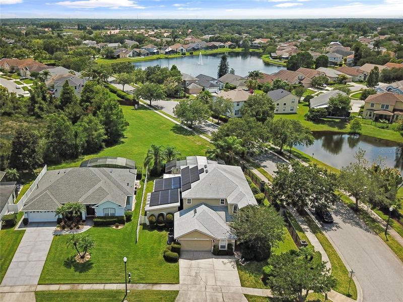 This spacious **CORNER-LOT** **POOL HOME** is located in the highly sought-after Eastwood Community in East Orlando with a **NEW ROOF/2020**, POND VIEW, SOLAR PANELS (low energy bills!) and a MUST SEE GAME ROOM & MOVIE THEATER!