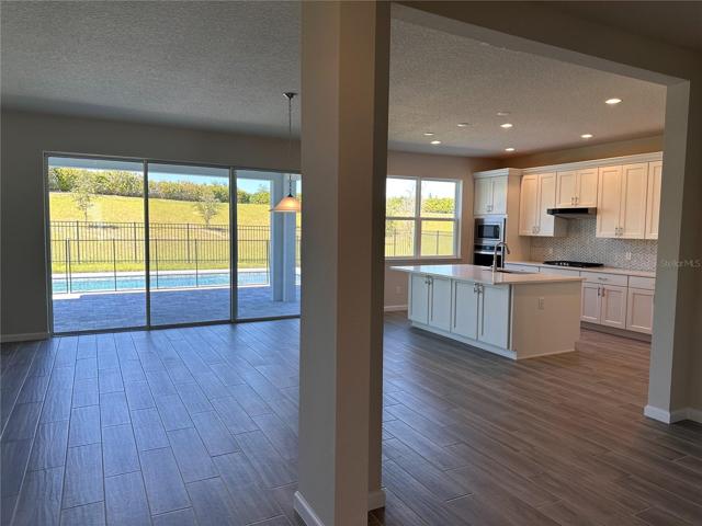 Enjoy expansive views of backyard from the open concept living area