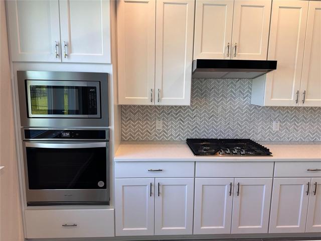 Upgraded gourmet kitchen with natural gas cooktop, wall oven and microwave