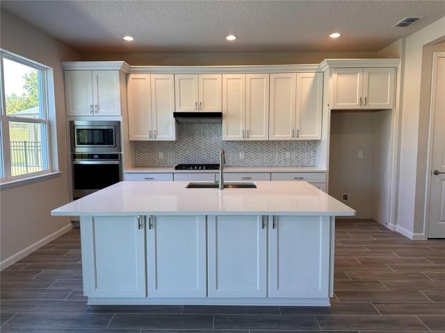 Oversized kitchen island with cabinetry on both sides