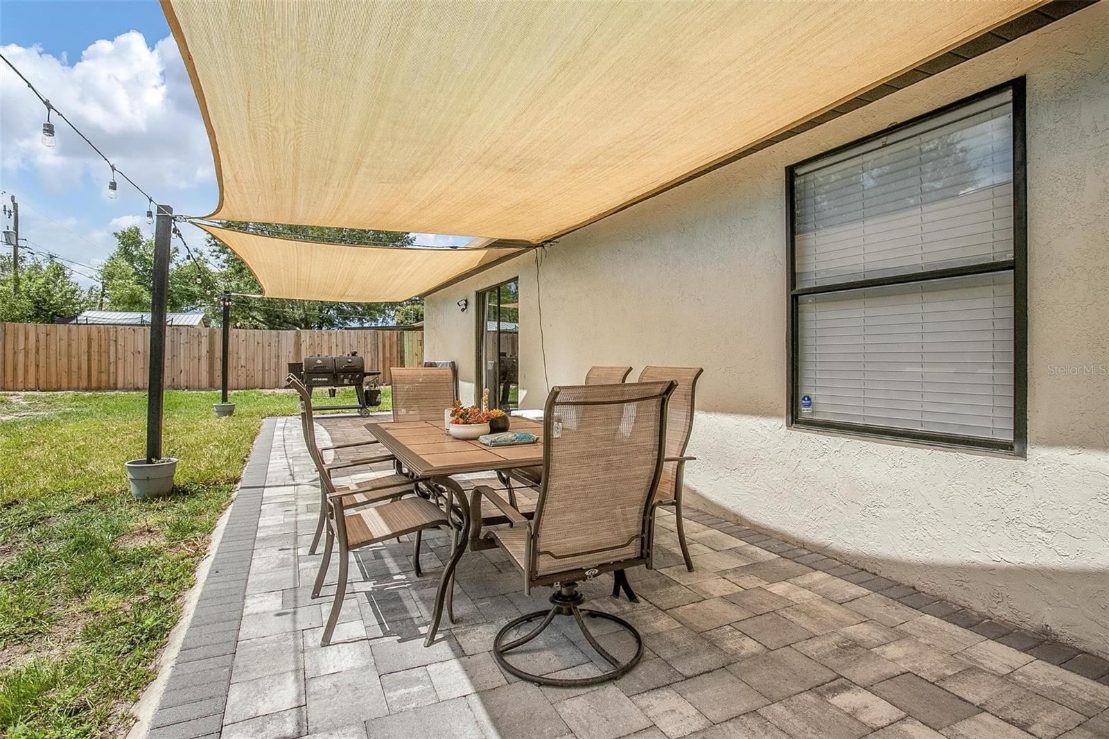 Paver patio in fenced back yard.