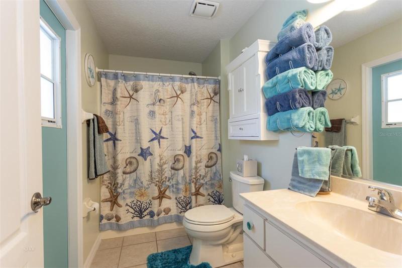 Guest full bathroom with direct pool access.