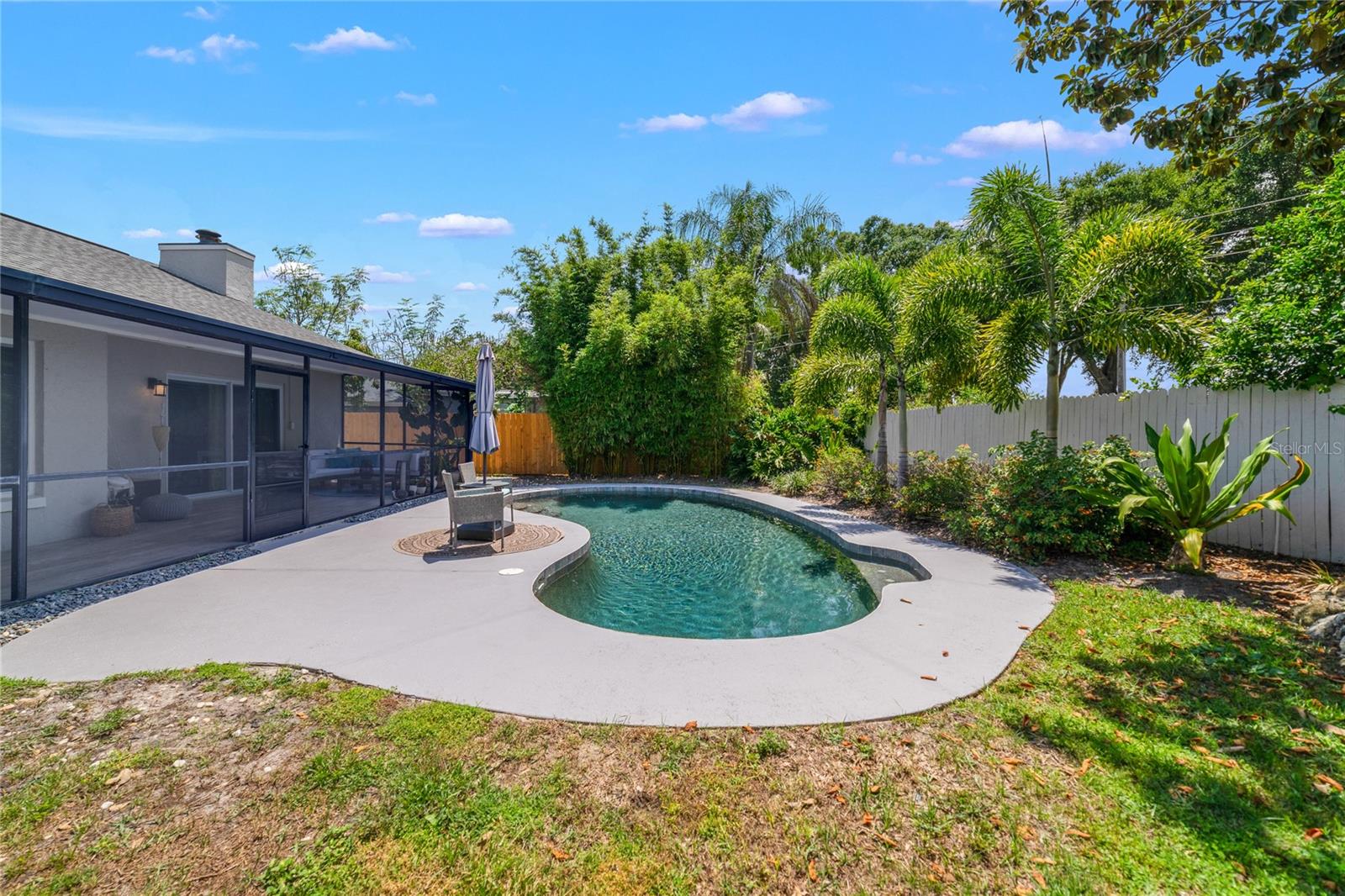 The landscaped backyard is fenced for privacy, providing a poolside oasis for outdoor enjoyment and entertaining!