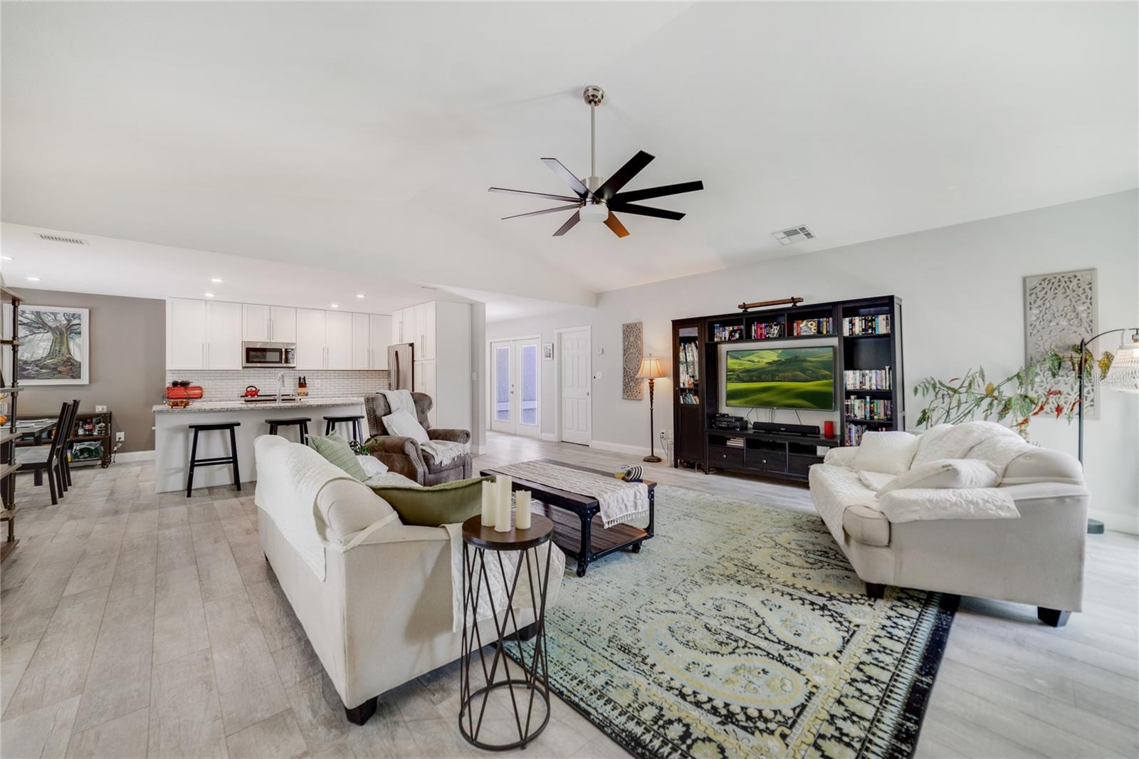 Your generous living area has oversized sliding glass to access the screened lanai and is open to a fantastic kitchen!