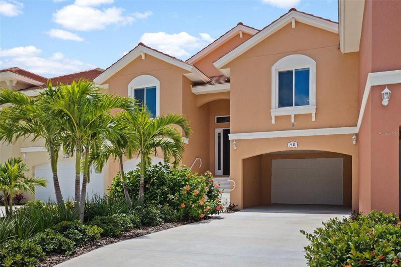 Front elevation showing Garage Level with carport and Living Level above.