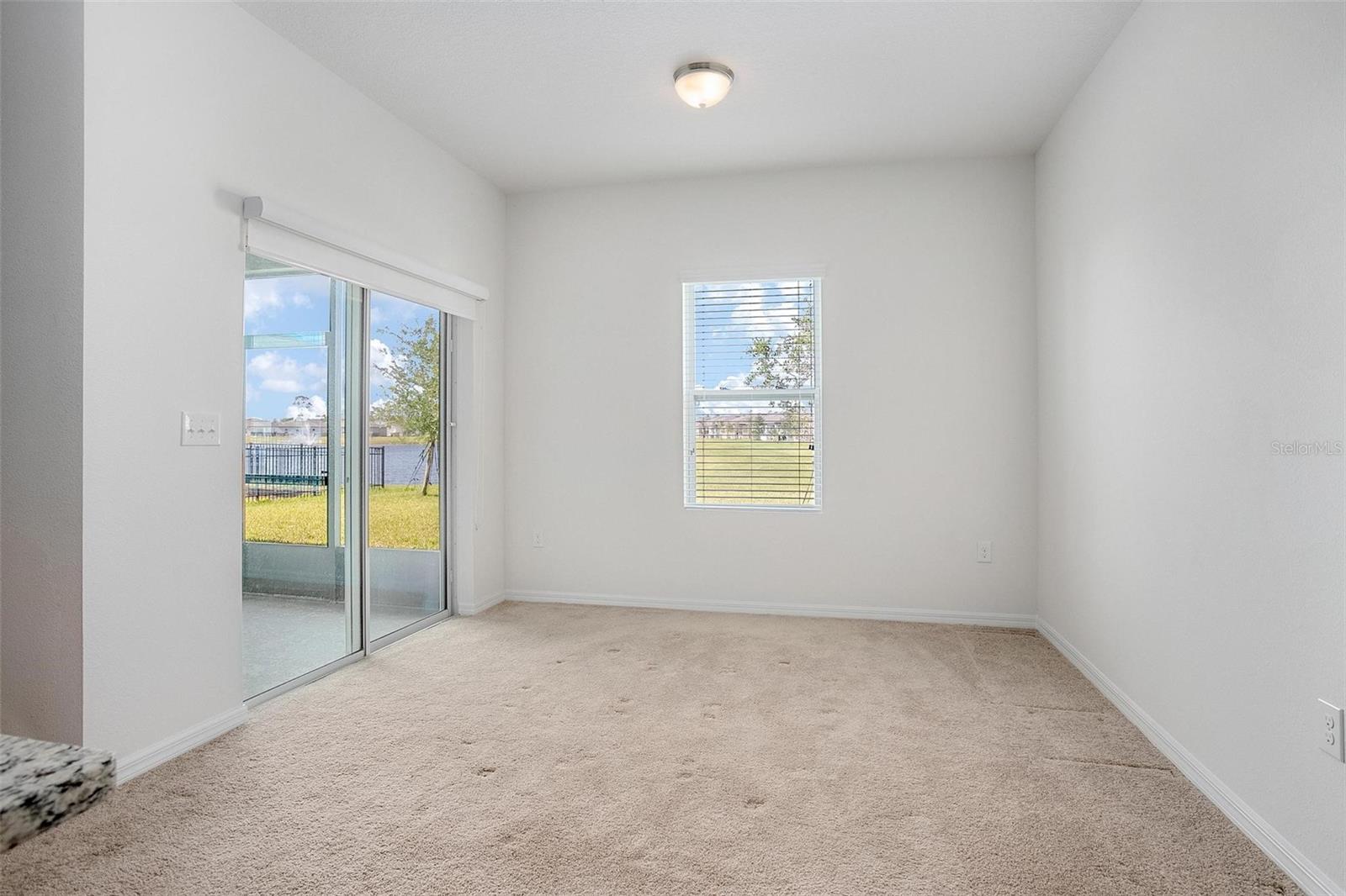 Dining room with access to screened lanai overlooking the pond.