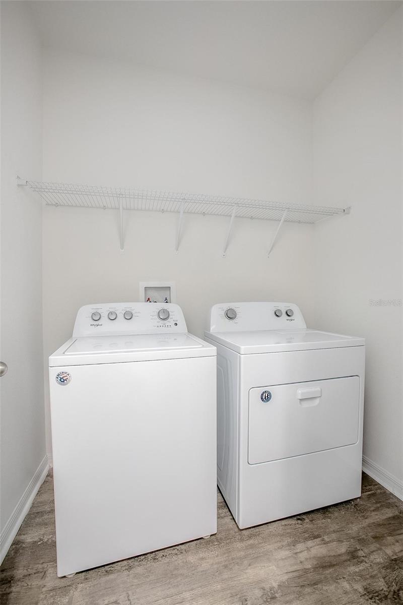 Convenient indoor laundry room. Washer and dryer convey.