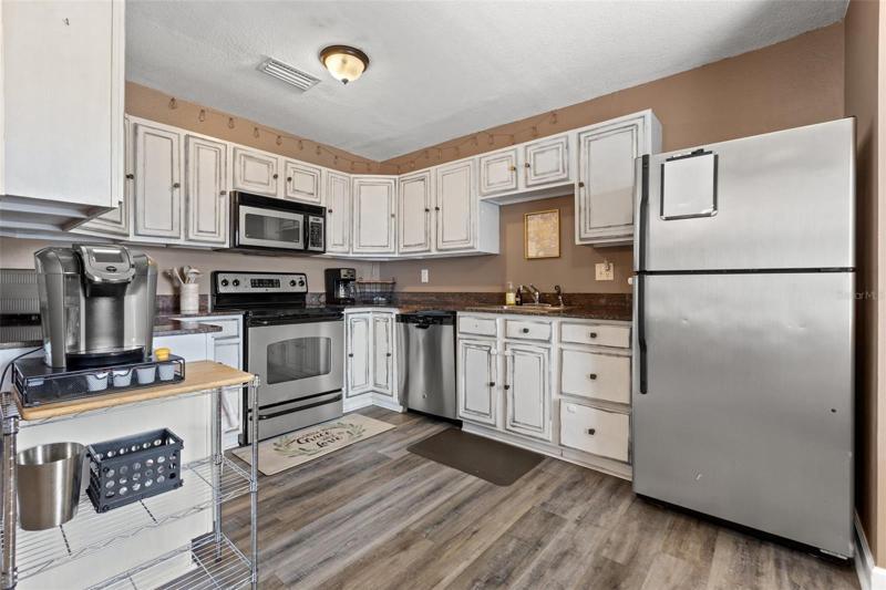 Spacious kitchen featuring granite counter tops and stainless steel appliances.
