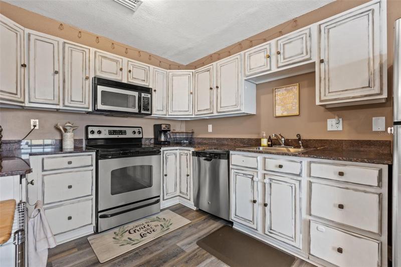 Spacious kitchen featuring granite counter tops and stainless steel appliances.
