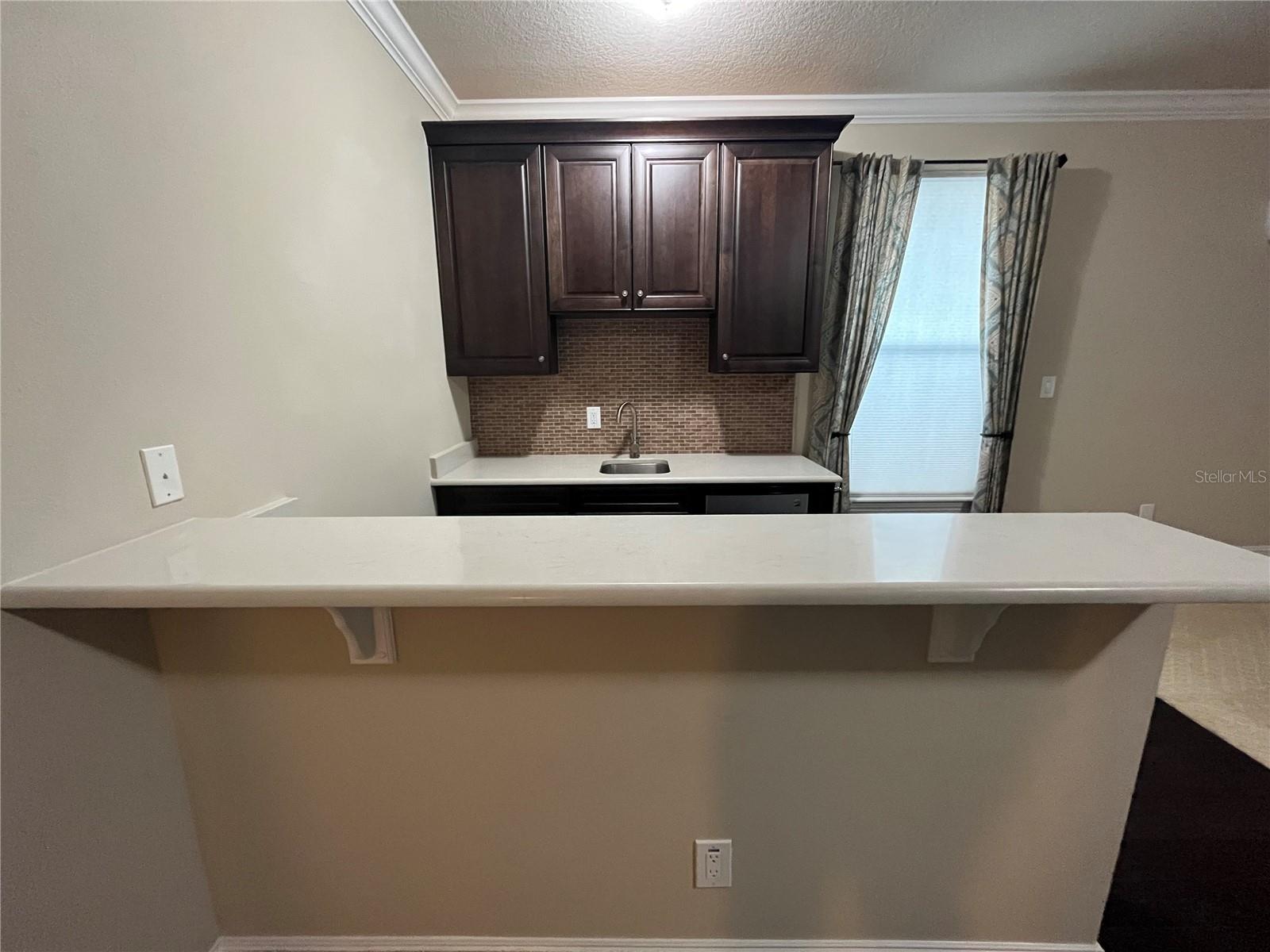 Bar has Built In Cabinetry