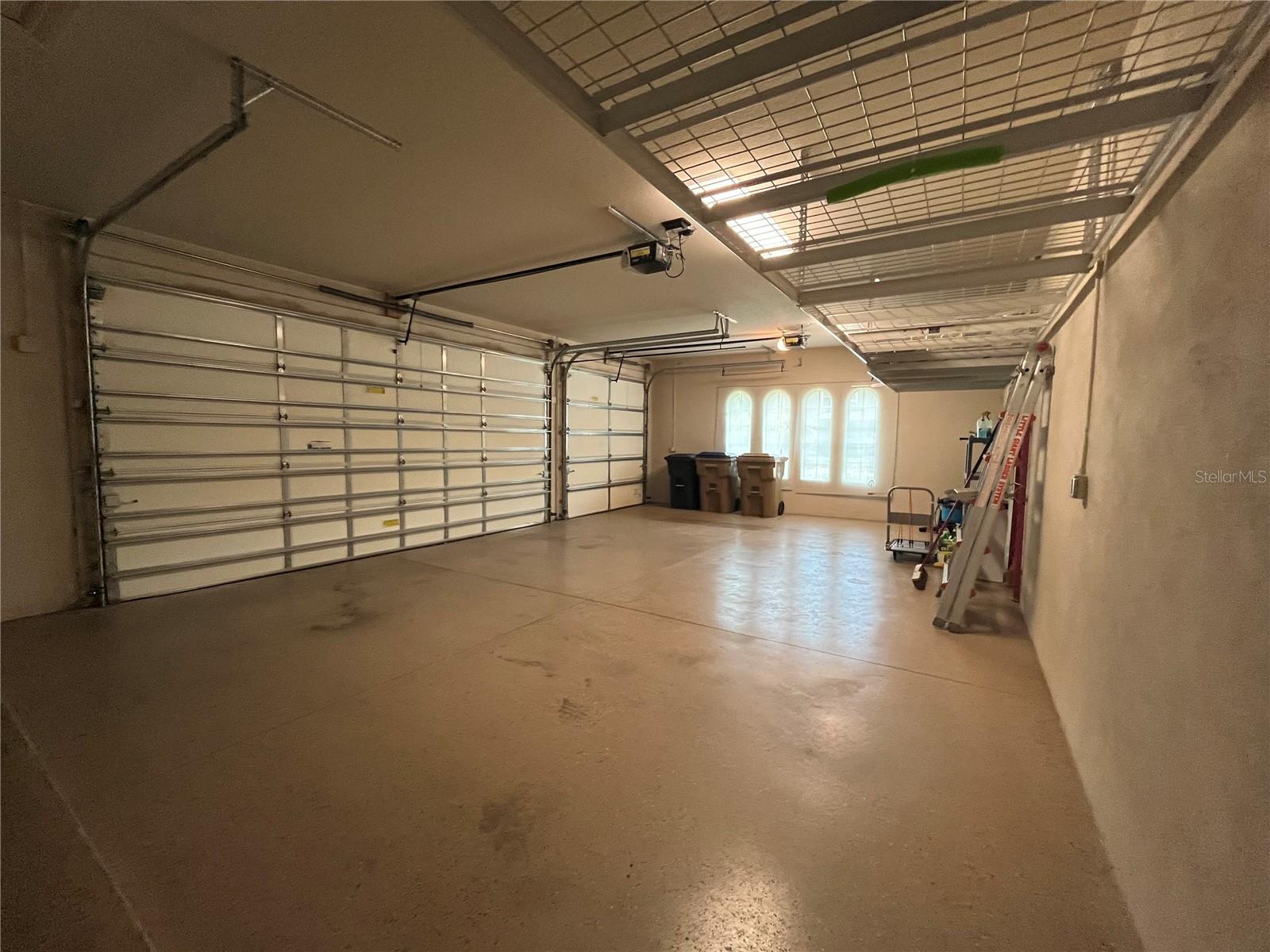 Heated and Air Conditioned 3 Car Garage with Insulated Garage Doors and Overhead Storage Racks