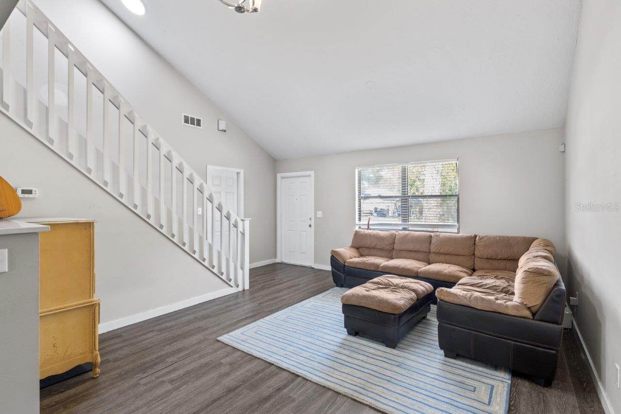 Right Unit: Open floorplan featuring cathedral ceilings up to the second floor, and laminate flooring throughout.