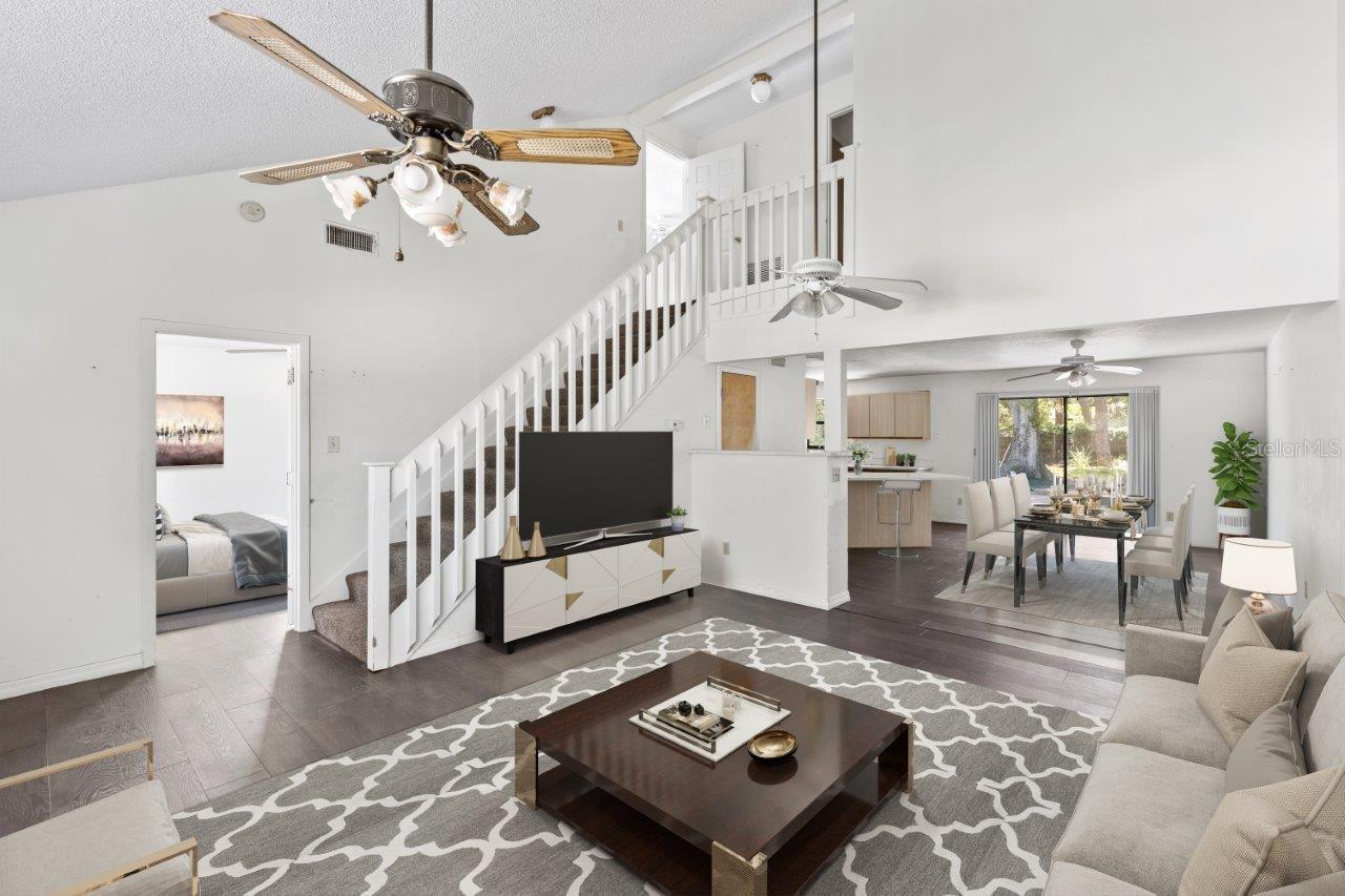 Left Unit: Open floorplan featuring cathedral ceilings up to the second floor, and laminate flooring throughout.