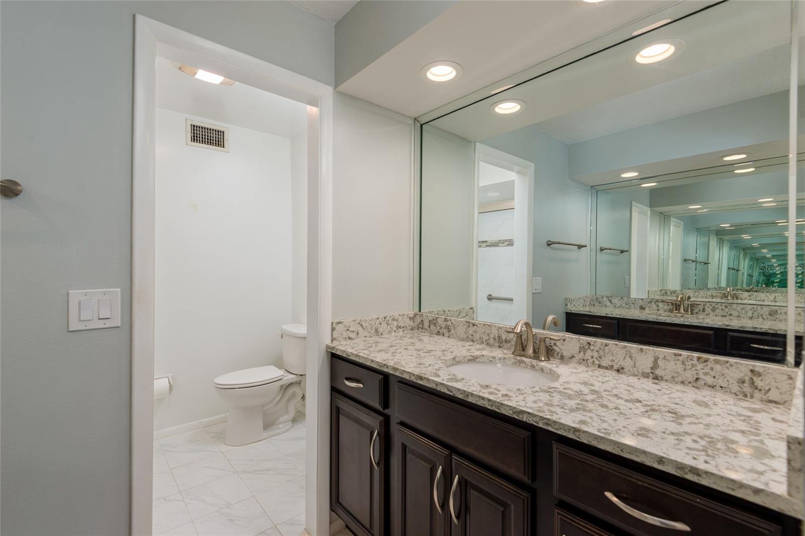 Updated master bathroom with high vanity.