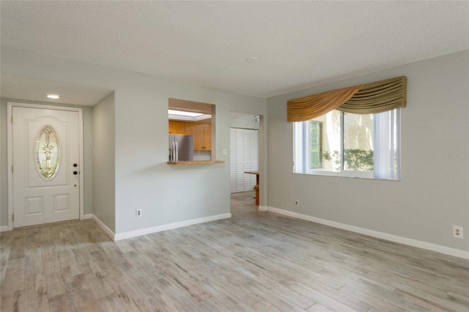 Entrance into unit with newer door and new baseboards.