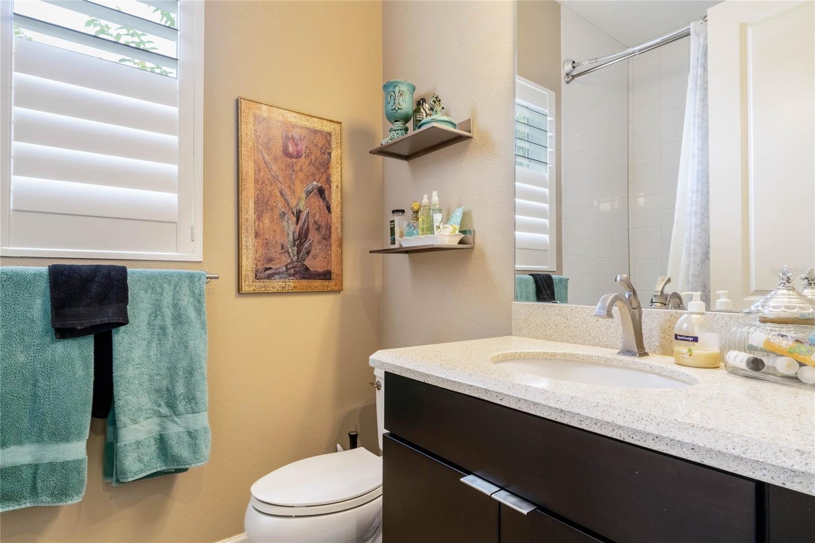 5'8" x 8' Guest Bath w/ single quartz countertop vanity & tub w/ shower