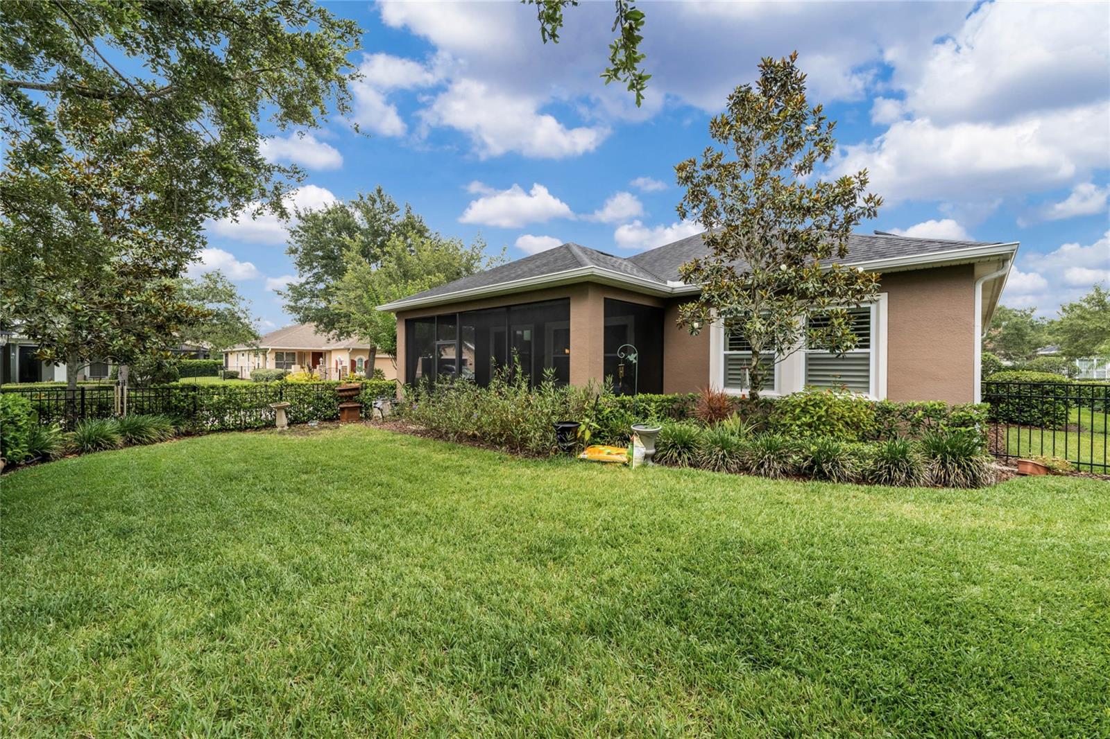 View of rear of home w/ fenced backyard