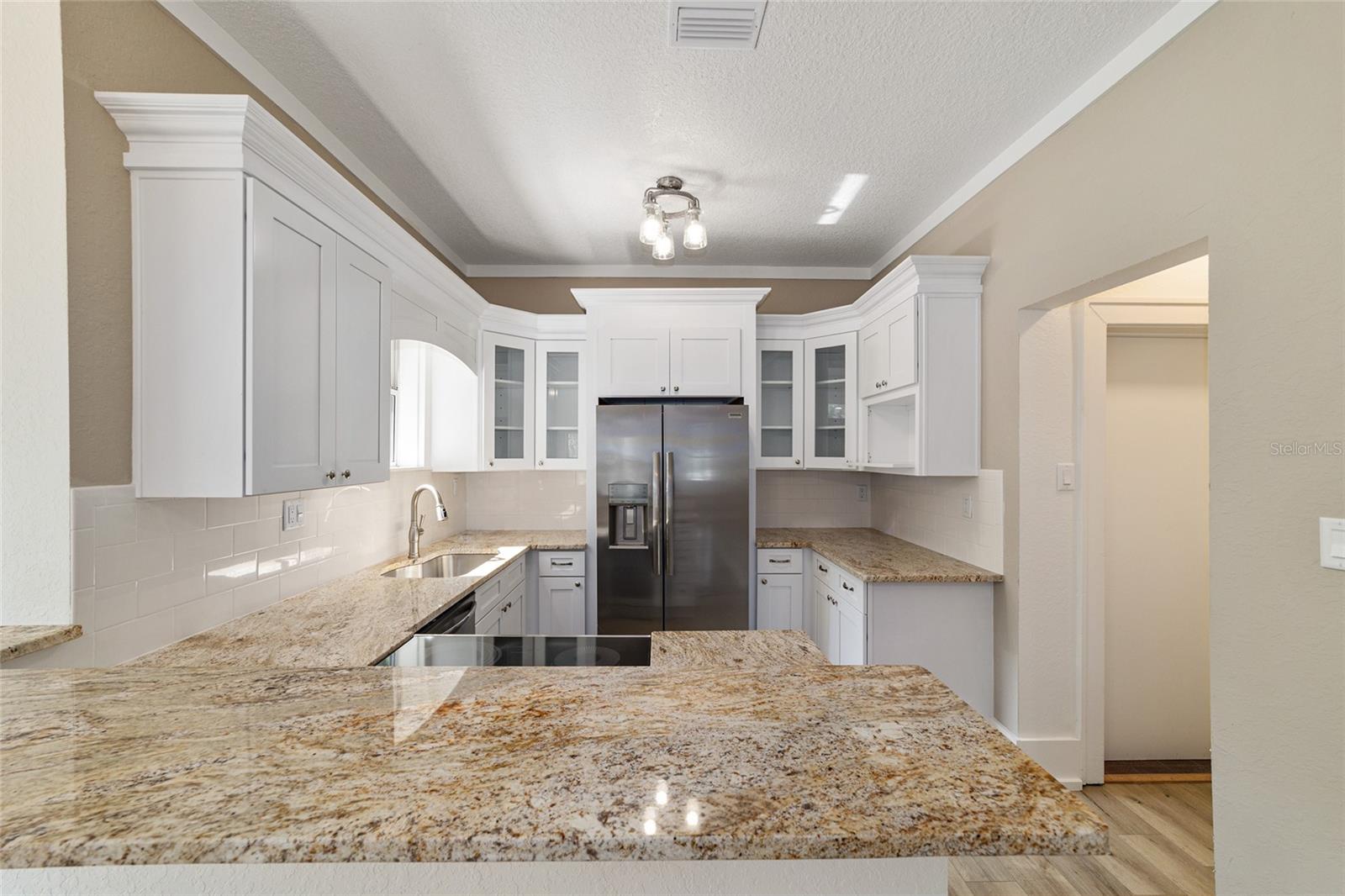 Stone countertops and stainless appliances.