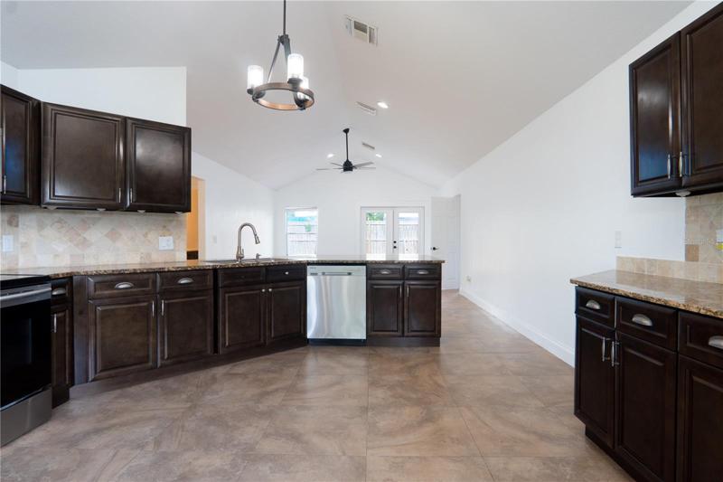 Kitchen with oven, refrigerator, storage cabinets.