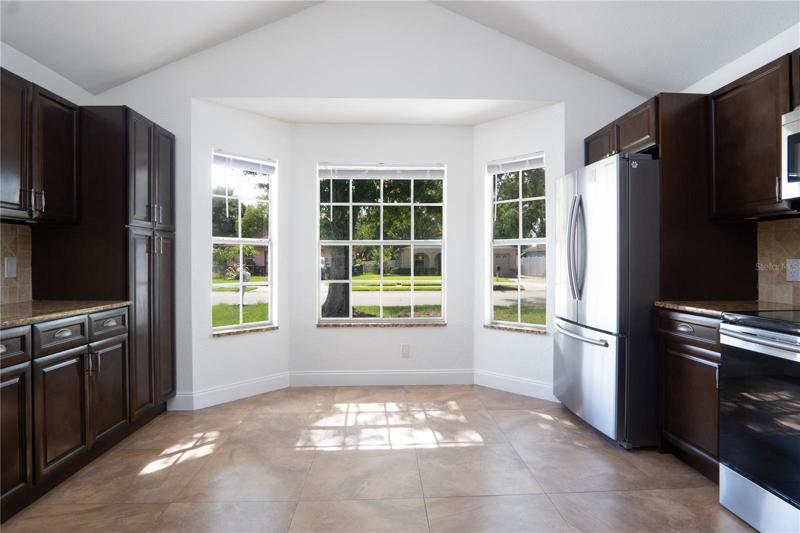 Kitchen with oven, refrigerator, storage cabinets.