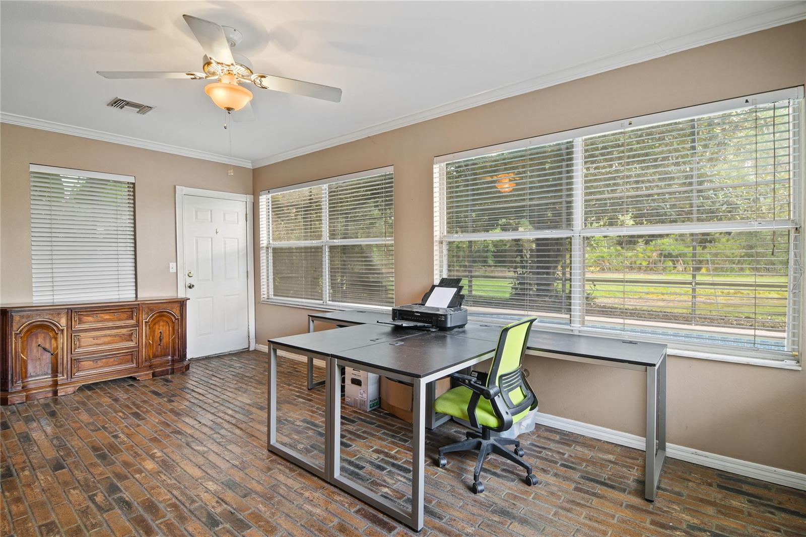 u will find additional flexible living space in the enclosed FLORIDA ROOM boasting a unique brick floor and a wall of windows to enjoy the Florida sunshine!