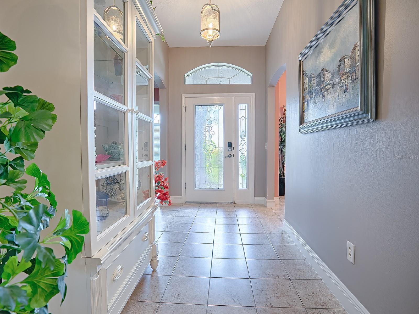 SPACIOUS FOYER ENTRY WITH TILE FLOORING.