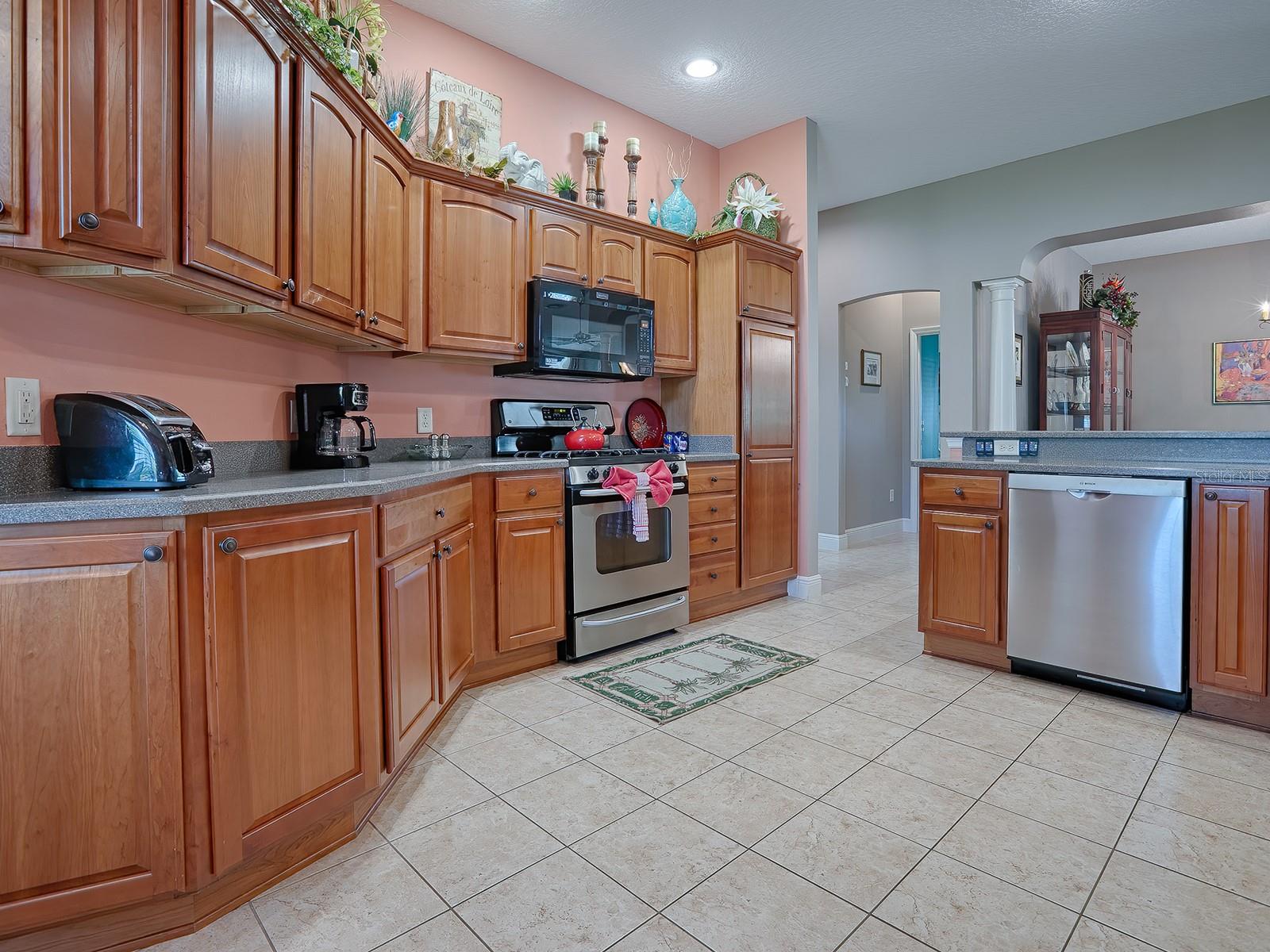 BEAUTIFUL HONEY MAPLE CABINETS WITH CROWN MOLDING, HARDWARE, AND PULLOUTS.