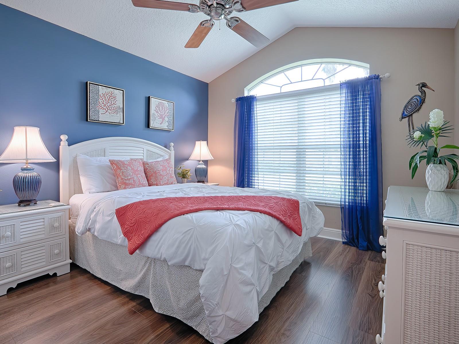 FRONT GUEST BEDROOM WITH VAULTED CEILING, WIDE PLANK LAMINATE FLOORING. A