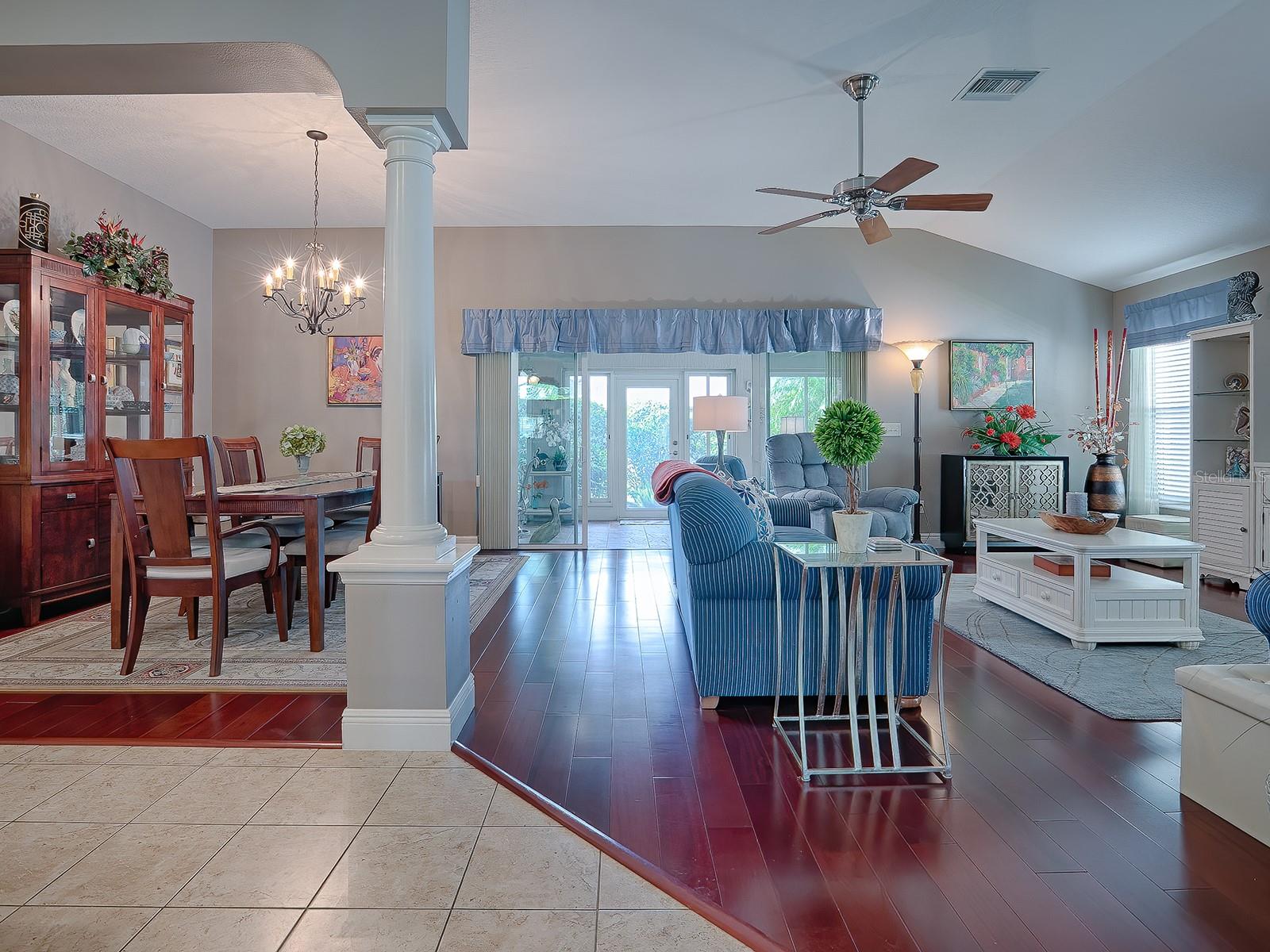 OPEN DINING ROOM AND LIVING ROOM WITH SLIDIING GLASS DOORS THAT LEAD OUT TO THE GLASS ENCLOSED LANAI!