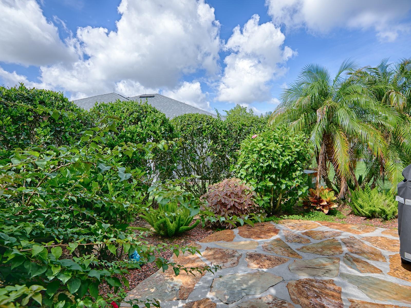 FLAGSTONE PATIO WITH LOVELY LANDSCAPED PRIVACY IN YOUR BACKYARD.  GREAT SPOT FOR YOUR GRILL TOO.