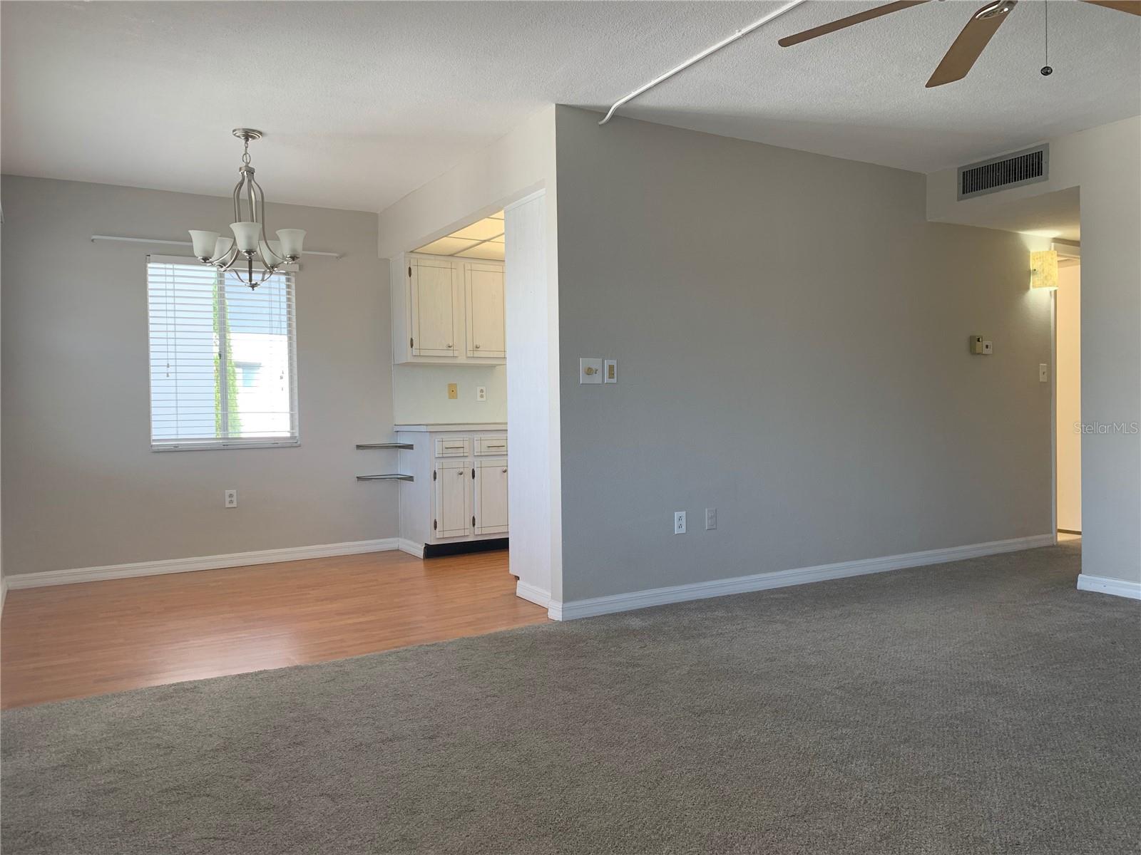 looking from the living room towards the dining area and kitchen; hallway to the right leads back to the huge bedroom and ensuite bathroom and walk-in closet