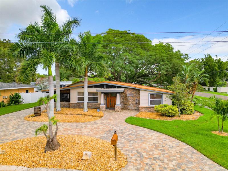 Front of house with beautiful paver driveway- plenty of parking for friends and family