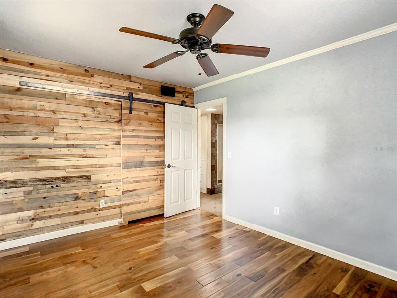 Master bedroom with barn door to closet