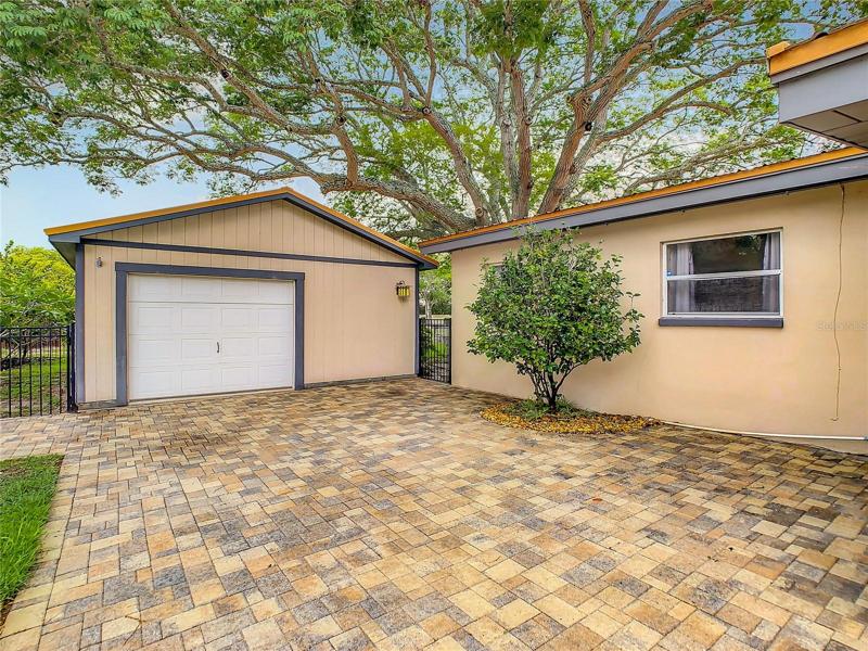 paver drive leading to garage