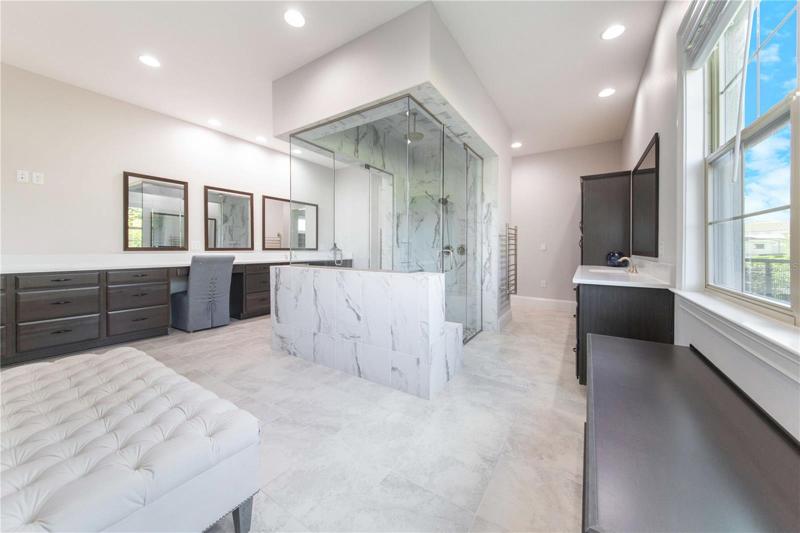 Luxurious Master Bath has Step in Shower, His and Hers Vanities, Dual Heated Towel Racks and Huge Walk In Closet beyond