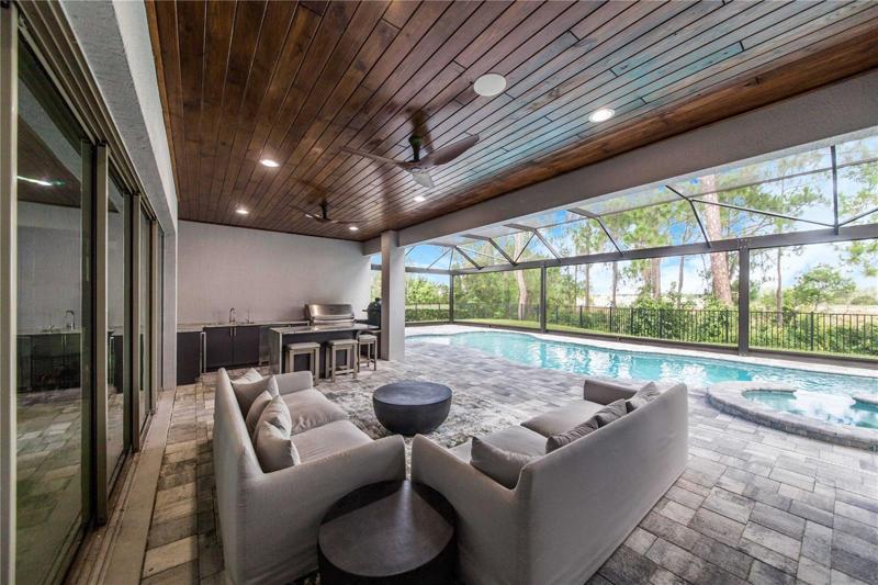 Back Lounge area has Summer Kitchen with Outdoor Fridge & Quartzite Countertops with Waterfall Edge