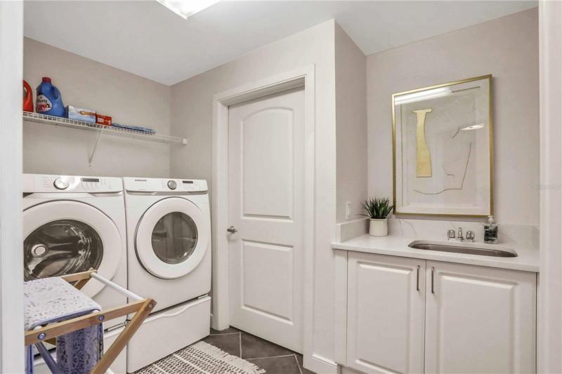 Laundry room with sink and extra cabinetry
