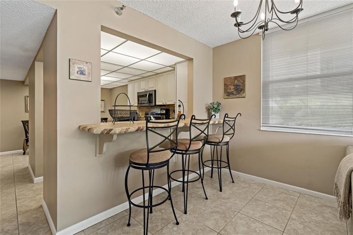 Breakfast bar plus dining area in kitchen.