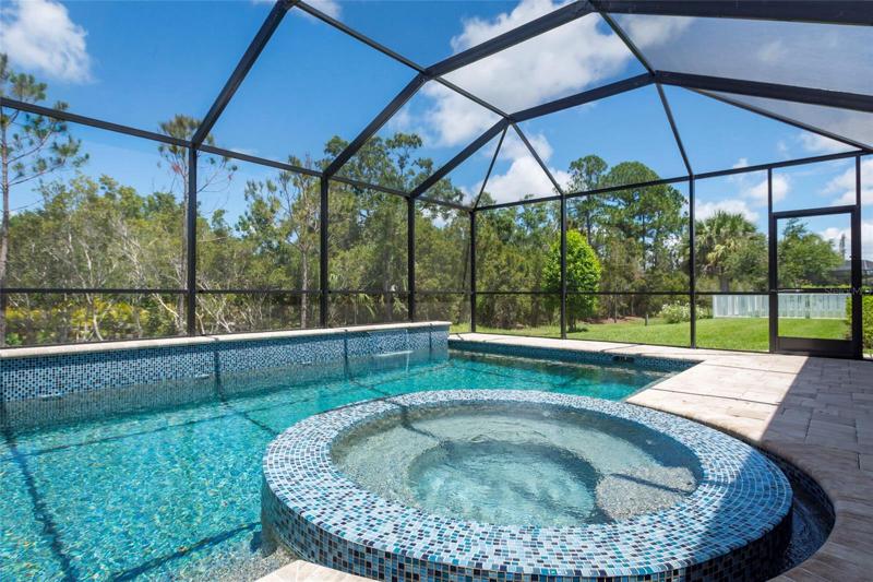 heated spa set inside the pool is perfect for watching sunset out back