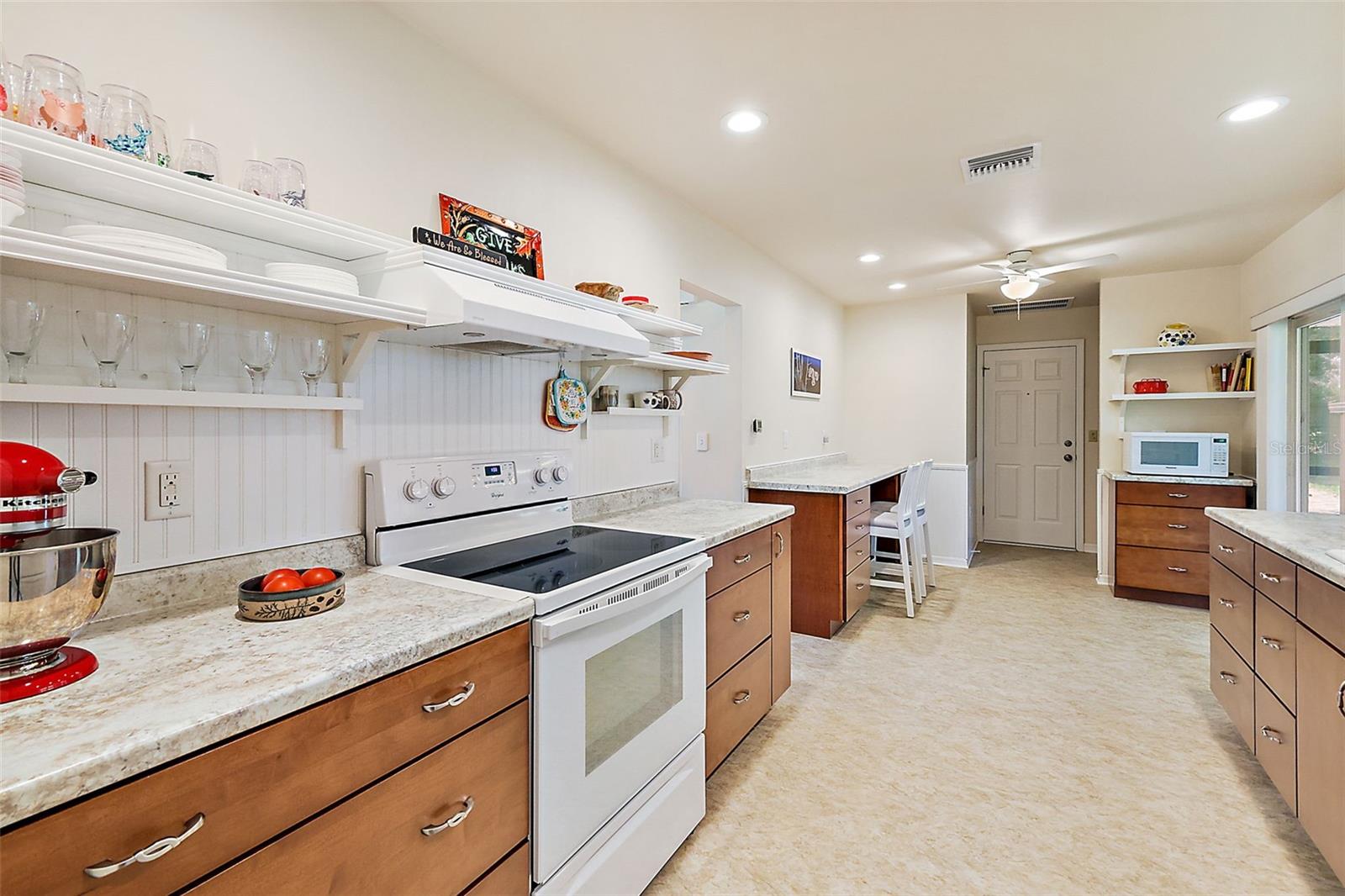 Lovely kitchen with loads of cabinetry drawers, extended to the dinette