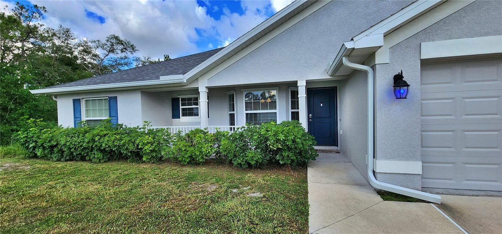 Sidewalk to front door with lighting.
