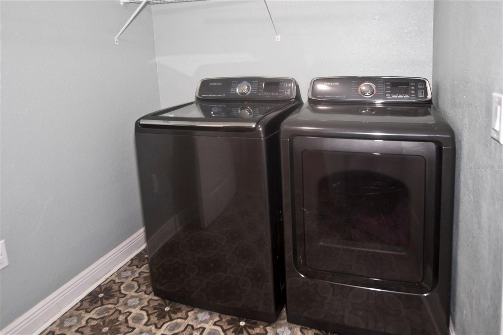 Laundry Room has shelves and closet.