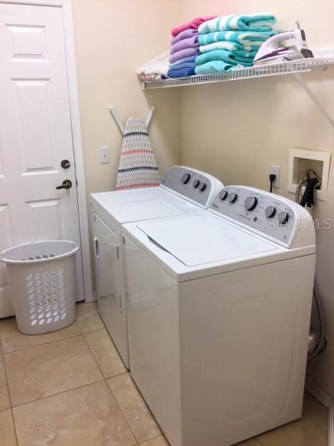 Laundry room across the hallway from the kitchen as well as providing access into the attached two car garage